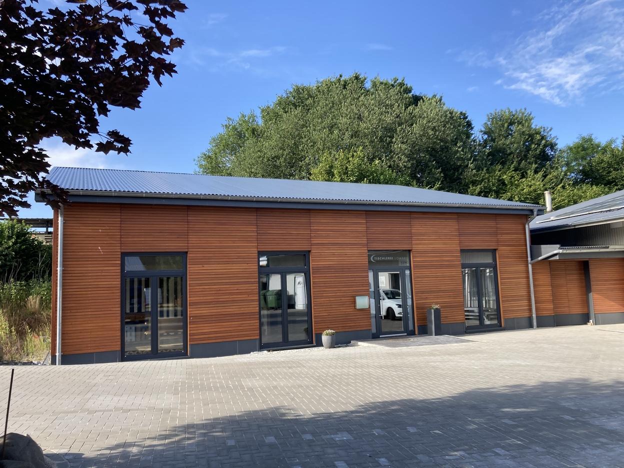 Pflasterarbeiten vor dem IDEEN REICH Gepflastert Fläche vor dem holzbraunen IDEEN REICH mit grauen Fenstern