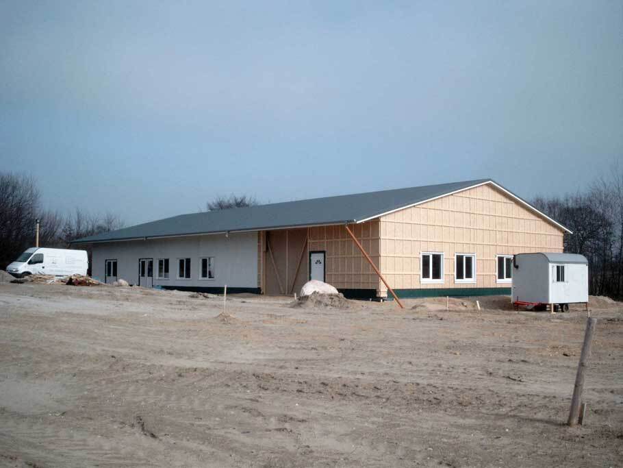 Rohbau der heutigen Werkstatt auf einer Sandfl&auml;che